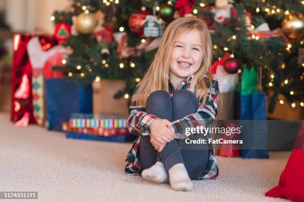 portrait of a young girl in front of the family christmas tree - kids advent stock pictures, royalty-free photos & images