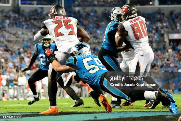 Luke Kuechly of the Carolina Panthers tackles Peyton Barber of the Tampa Bay Buccaneers for a safety in the fourth quarter during their game at Bank...