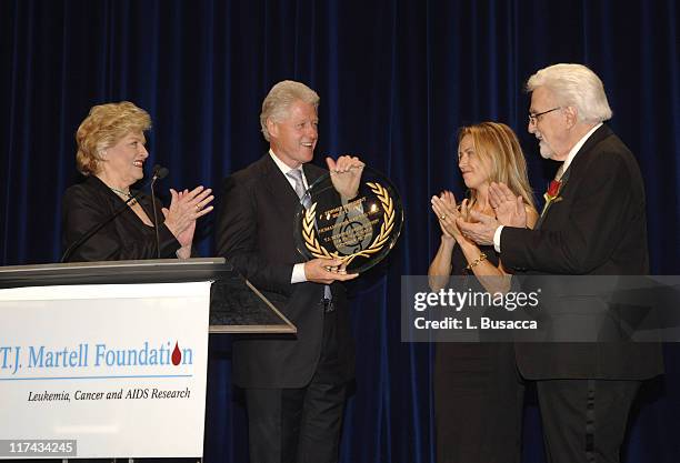 Frances Preston, President of the T.J. Martell Foundation, Sheryl Crow and Tony Martell present Former President Bill Clinton with the Humanitarian...