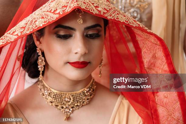 bridal wear that stays true to her beliefs - indian bridal makeup stock pictures, royalty-free photos & images