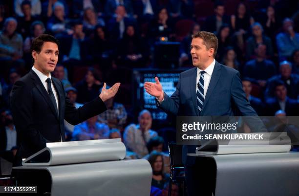 Conservative leader Andrew Scheer and Canadian Prime Minister and Liberal leader Justin Trudeau gesture to each other as they both respond during the...