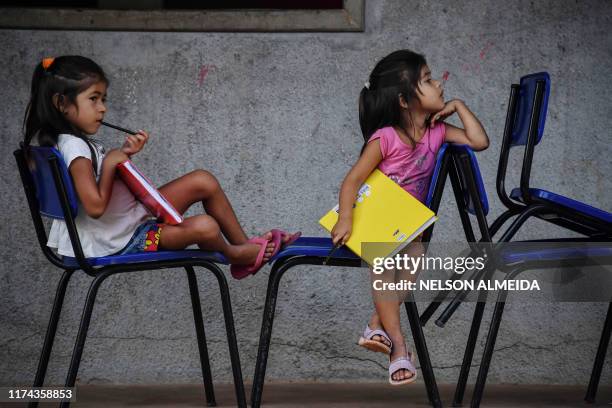 Munduruku indigenous girls wait for a class at a school in Praia do Mangue indigenous reserve, in Itaituba, Para state, Brazil, in the Amazon...