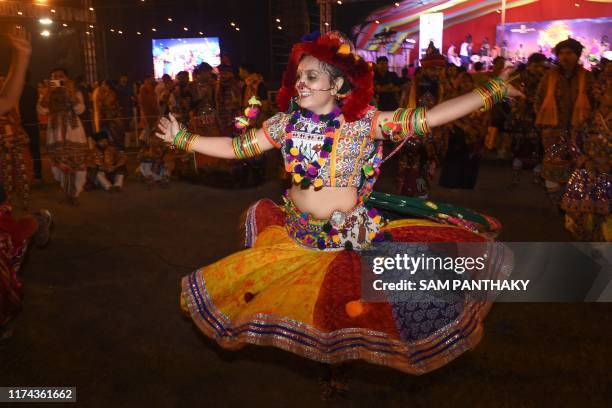 In this photo taken October 7, 2019 an Indian garba performer dances during a celebration on the last night of the Hindu Navratri festival in...