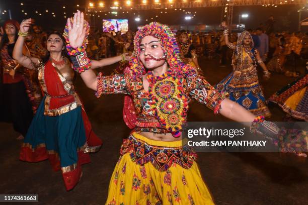 In this photo taken October 7, 2019 Indian garba performers dance during a celebration on the last night of the Hindu Navratri festival in Ahmedabad.