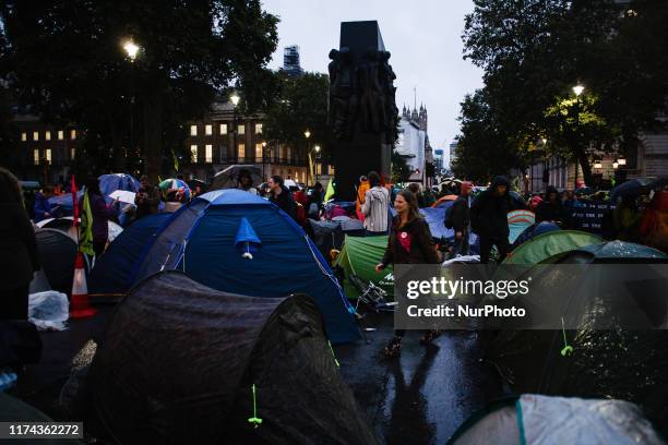 Tents for members of climate change activist group Extinction Rebellion block Whitehall as darkness falls on the opening day of the group's...