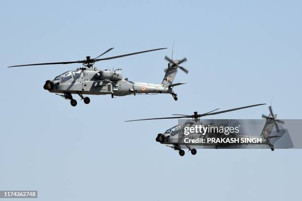 Apache helicopters fly past during the Air Force Day parade at an IAF station in Ghaziabad, on the outskirts of New Delhi, on October 8, 2019. - The...