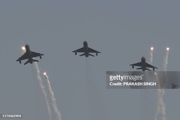 Indian Air Force Mig-21 Bison fighter jets led by Wing Commander Abhinandan Varthaman fly past during the Air Force Day parade at an IAF station in...