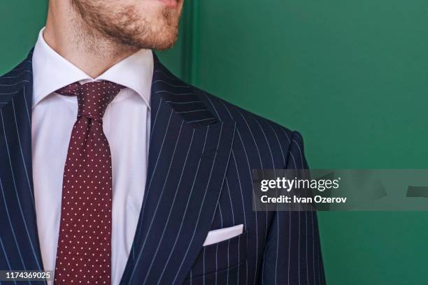 man wearing pinstripe blazer with spotted tie - nadelstreifen stock-fotos und bilder