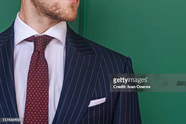 man wearing pinstripe blazer with spotted tie - bavero foto e immagini stock
