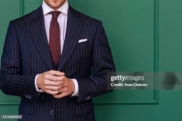 man wearing pinstripe blazer with spotted tie - striped jacket stock-fotos und bilder