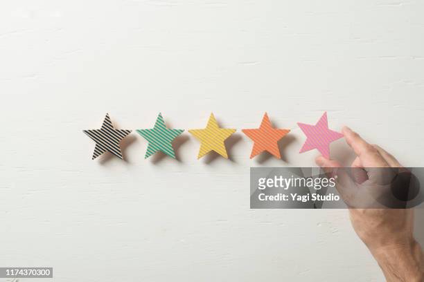 colorful wooden five star shape on white table. - first choice stock pictures, royalty-free photos & images