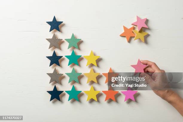 colorful wooden stars lined up in steps - scoring system stock pictures, royalty-free photos & images