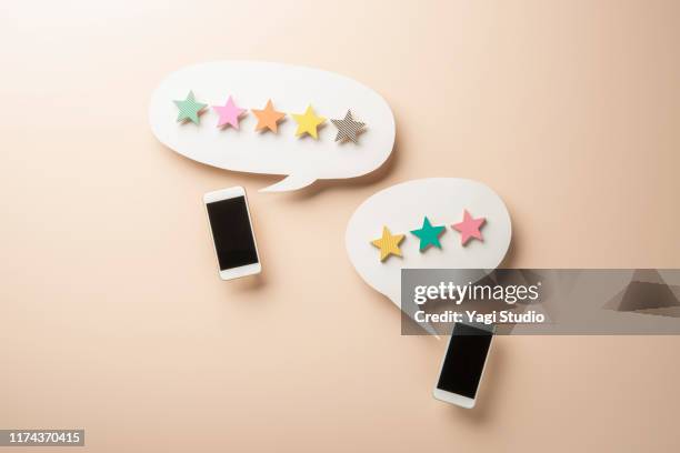 wooden five star shape with chat bubble and smart phone. - celebrity connected stockfoto's en -beelden