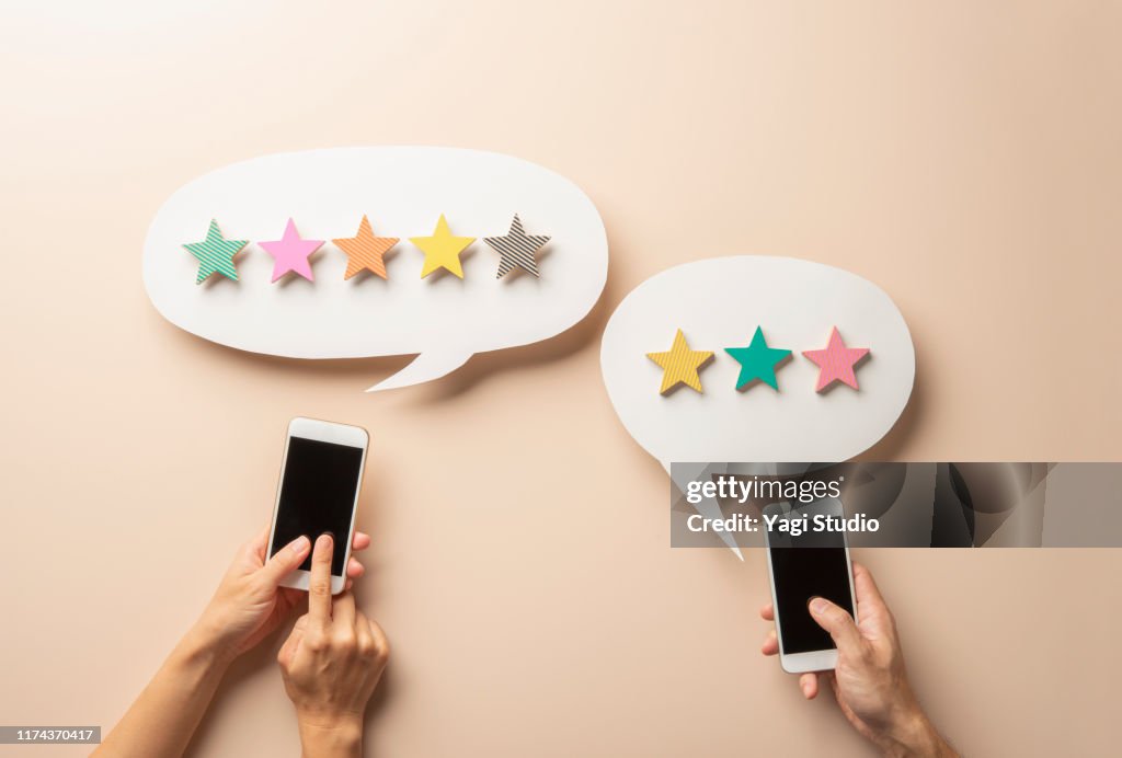 Wooden five star shape with Chat Bubble and smart phone.