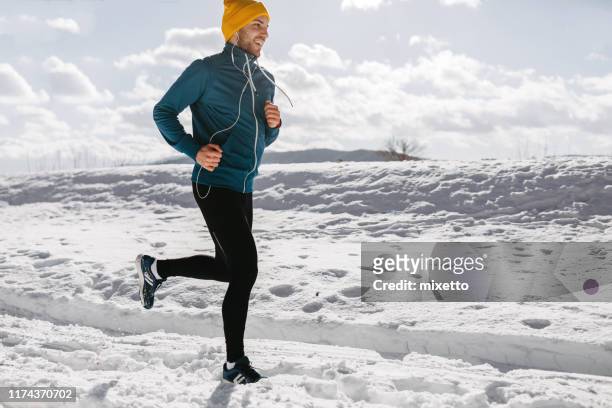 jogging in the winter morning - winter running stock pictures, royalty-free photos & images