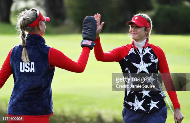 Nelly Korda and Jessica Korda of Team USA high five on the fifth green during Day 1 of The Solheim Cup at Gleneagles on September 13, 2019 in...