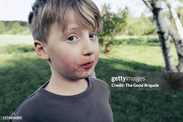 portrait of boy with messy face - ertappt stock-fotos und bilder