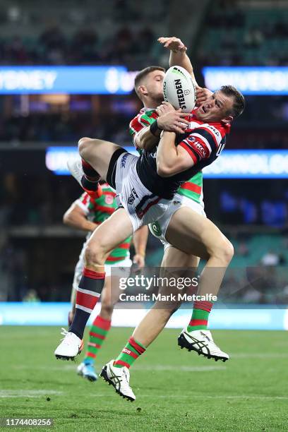 Brett Morris of the Roosters and Adam Doueihi of the Rabbitohs compete for the ball in the air during the NRL Qualifying Final match between the...