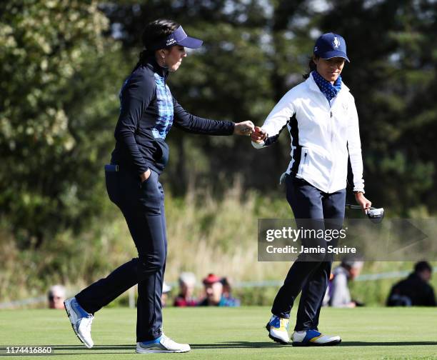 Georgia Hall and Celine Boutier of Team Europe bump fists on the fifteenth green during Day 1 of The Solheim Cup at Gleneagles on September 13, 2019...