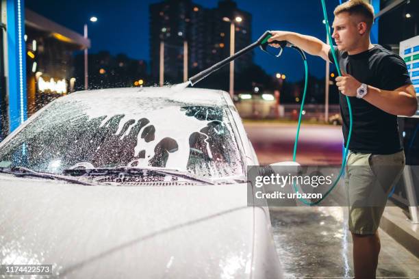 self service car wash - close up of a cleansing spray nozzle stock pictures, royalty-free photos & images