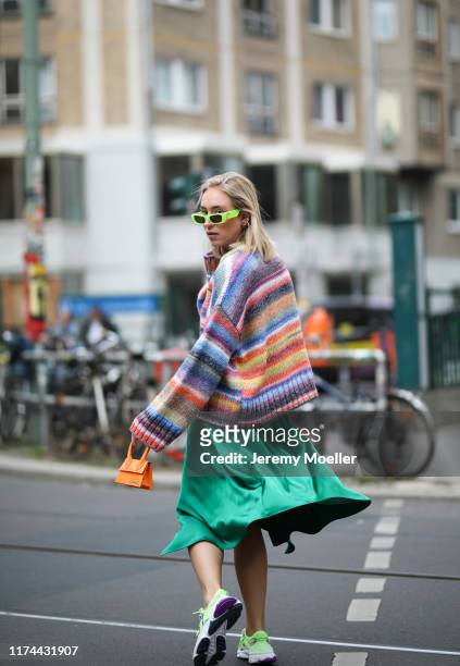 Sonia Lyson wearing Adidas Ozweego Sneaker, Gucci sunglasses, Jacquemus bag, Edited sweater and Zara skirt on September 13, 2019 in Berlin, Germany.
