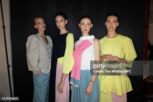 Models poses for a photograph ahead of the Gayeon Lee show during London Fashion Week September 2019 at Foyles on September 13, 2019 in London,...
