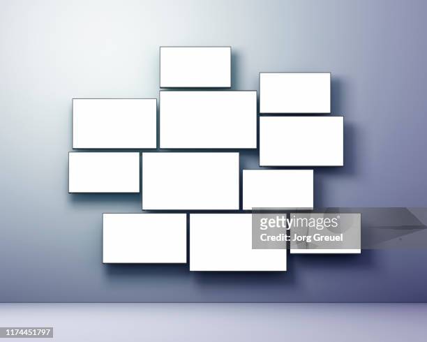 multiple flat screen tvs in various sizes - tv on wall stockfoto's en -beelden
