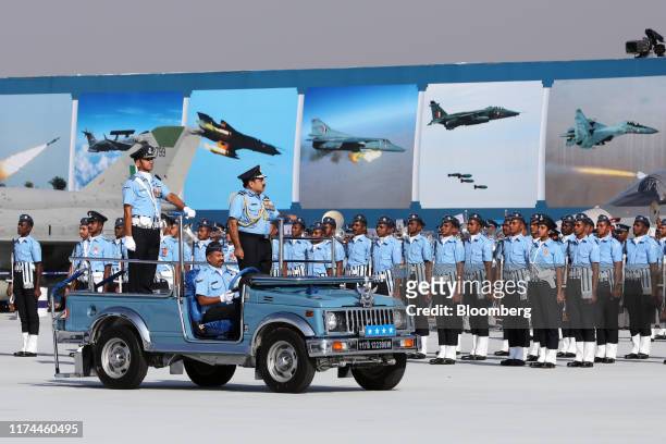 Rakesh Kumar Singh Bhadauria, chief of Air Staff for the Indian Armed Forces , right, inspects a drill from a vehicle during the Air Force Day Parade...