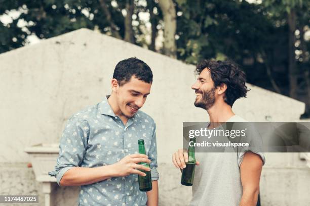 friends having a laugh - male friends drinking beer stock pictures, royalty-free photos & images