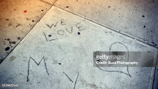 handwritings left on cement blocks on sidewalk - heart scar stockfoto's en -beelden