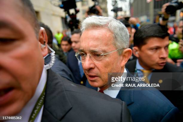 Former Colombian President and Senator Alvaro Uribe arrives to the Palace of Justice for a hearing before the Supreme Court of Justice in a case over...