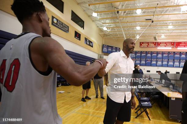 Jimmy Butler of the Miami Heat talks with Retired NBA Player, Alonzo Mourning during Training Camp on October 3, 2019 at American Airlines Arena in...