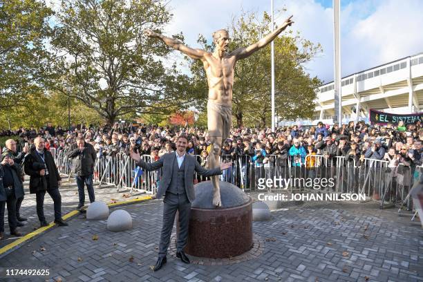 Sweden's biggest football star, Los Angeles Galaxy's forward Zlatan Ibrahimovic poses next to the 2,7 m bronze statue of him, after the unveiling...