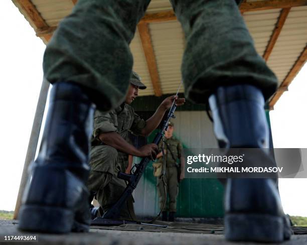 Soldier of the 7th Russian ground forces military base disassembles a machinegun during a training session in Gudauta some 60 km outside Sukhumi on...