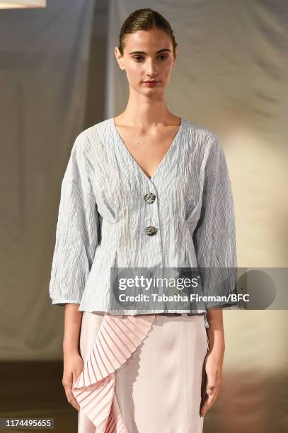 Model walks the runway at the Gayeon Lee show during London Fashion Week September 2019 at Foyles on September 13, 2019 in London, England.