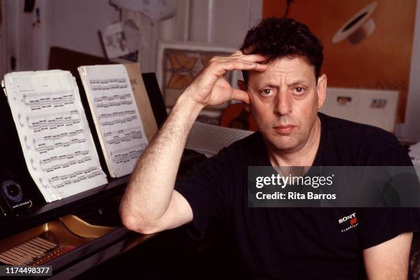 Portrait of American composer Philip Glass as he sits at a piano in an East Village apartment, New York, New York, September 11, 1990.