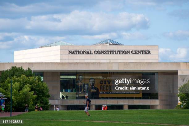 people walking in front of national constitution center in philadelphia - national constitution center stock pictures, royalty-free photos & images