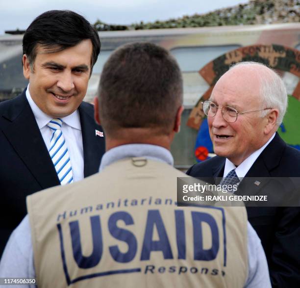 Vice President Dick Cheney and Georgian President Mikheil Saakashvili examine speak to a USAID employee in Tbilisi on September 4, 2008. After talks...