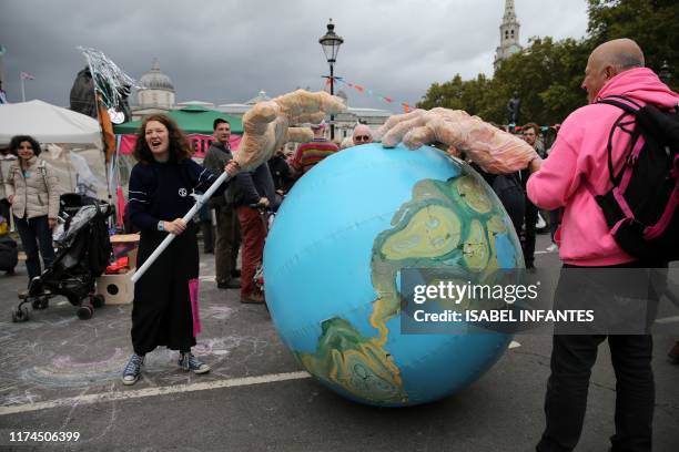 Activists protest near Trafalgar Square during the second day of climate change demonstrations by the Extinction Rebellion group in central London,...