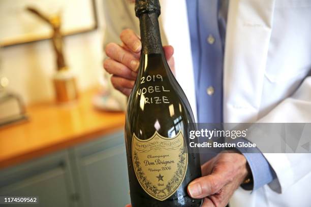 William G Kaelin, Jr. Holds up a bottle of celebratory champagne at the Dana-Farber Cancer Institute in Boston on Oct. 7, 2019. Kaelin was awarded...