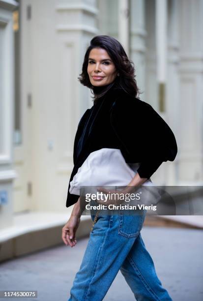 Victoria Barbara is seen wearing black Khaite top, Balenciaga denim jeans, Bottega Veneta clutch during New York Fashion Week September 2019 on...