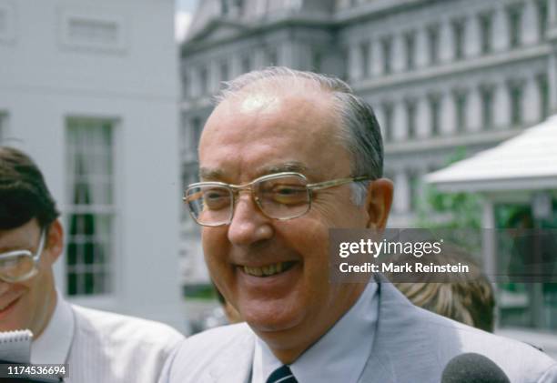 Republican Senator from North Carolina Jesse Helms talks to reporters in the West Wing driveway of the White House after attending a bipartisan...