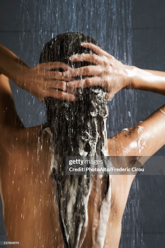 Woman washing her hair in shower