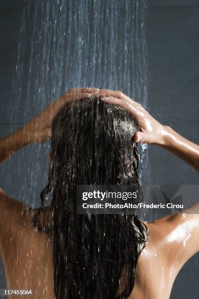 woman washing her hair in shower - wet hair conditioner stock pictures, royalty-free photos & images