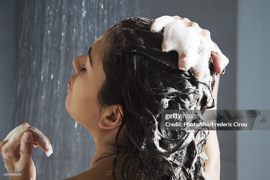 Woman washing her hair in shower