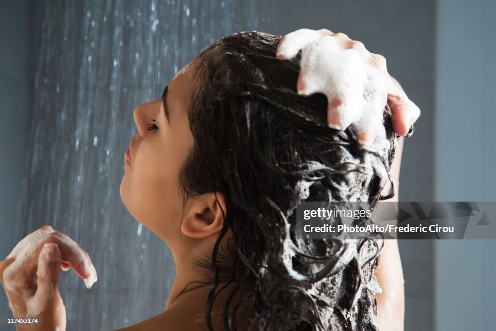 Woman washing her hair in shower