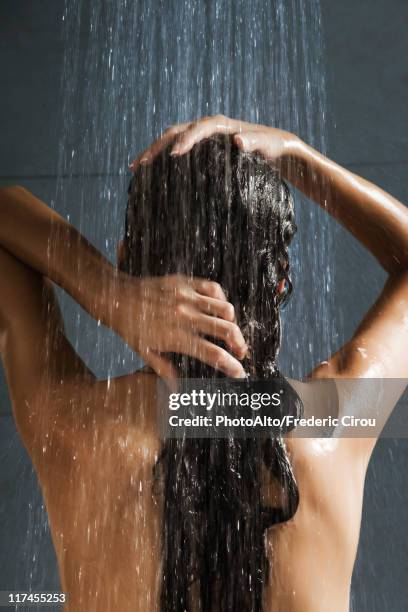 woman washing her hair in shower - wet hair conditioner stock pictures, royalty-free photos & images