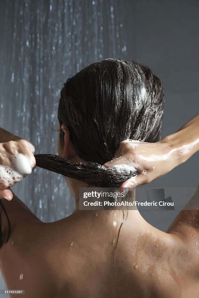 Woman washing her hair in shower