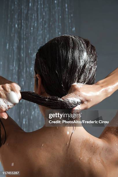 woman washing her hair in shower - wet hair conditioner stock pictures, royalty-free photos & images