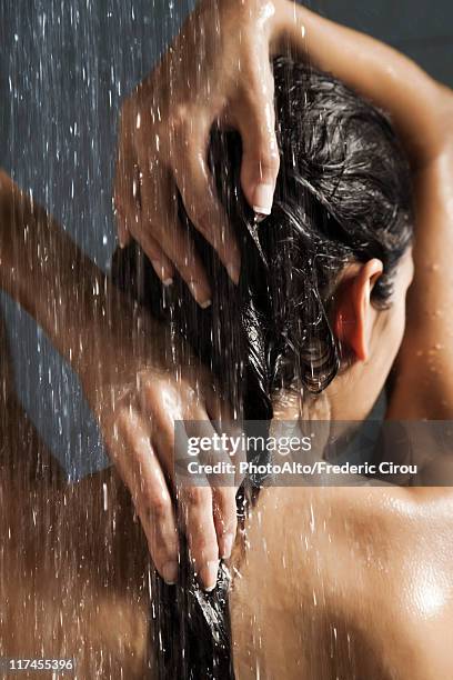 woman washing her hair in shower - wet hair conditioner stock pictures, royalty-free photos & images
